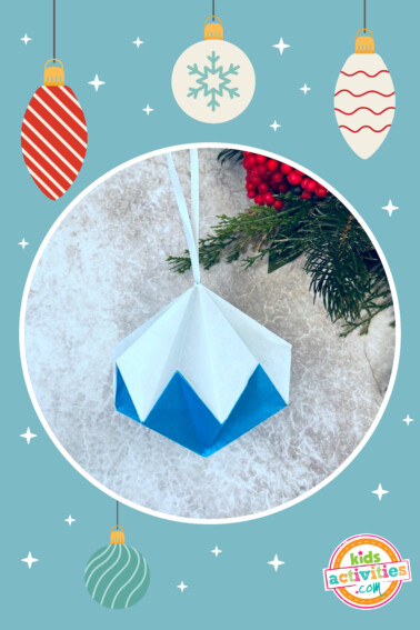 Image shows a finished origami ornament in red and blue hanging from a tree. from Kids Activities Blog