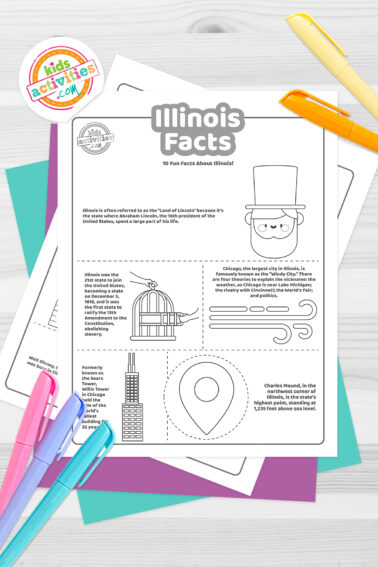 Black and white coloring pages with Illinois facts lying on top of blue-green and purple sheets with assorted crayons on a dark grey background.